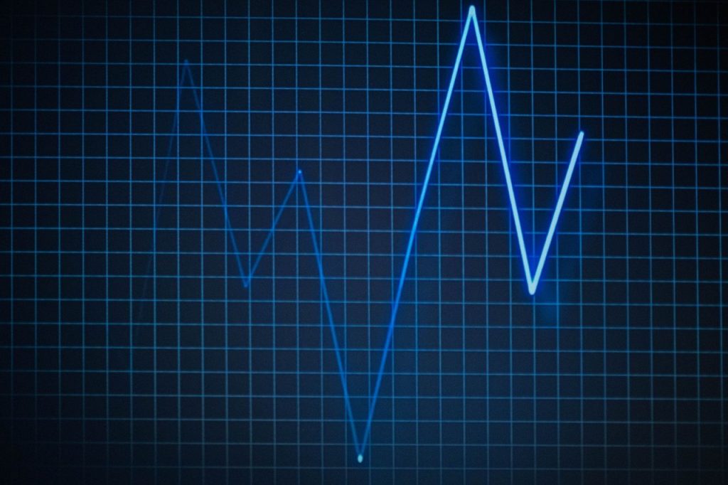 Gráfico de eletrocardiograma sobre uma grade, simbolizando dados e monitoramento digital da saúde.
